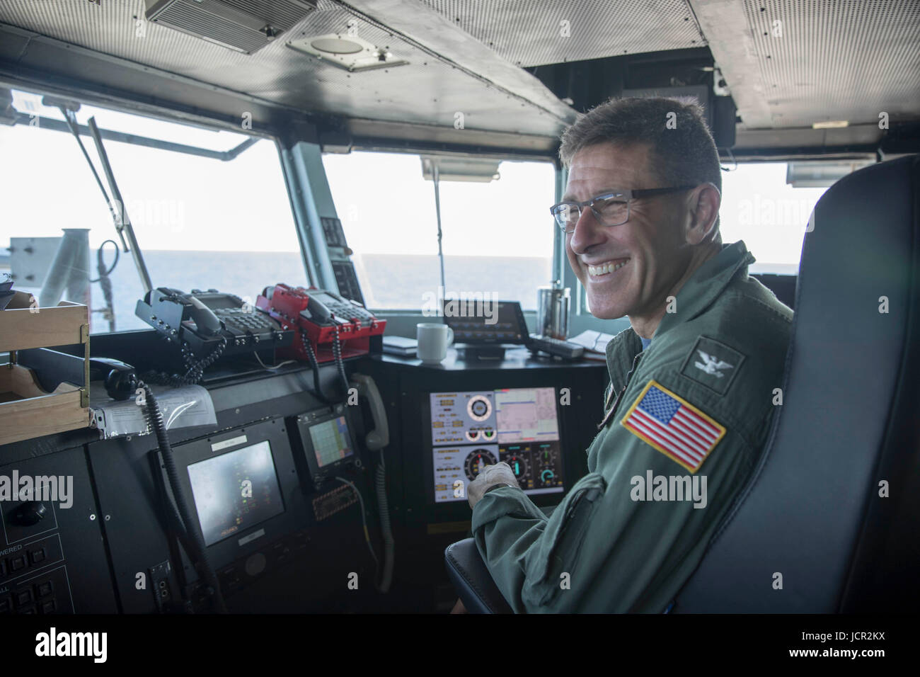 USS Abraham Lincoln Commanding Officer Putnam Browne smiles after he successful tried his hand at using the aircraft capture system on the flight deck of the USN Nimitz-class aircraft carrier USS Abraham Lincoln June 3, 2017 in the Atlantic Ocean. Stock Photo