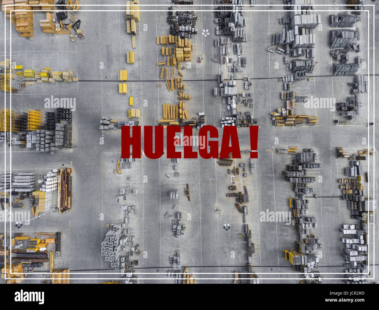 Word Huelga in spanish language. Industrial storage place, view from above. Stock Photo