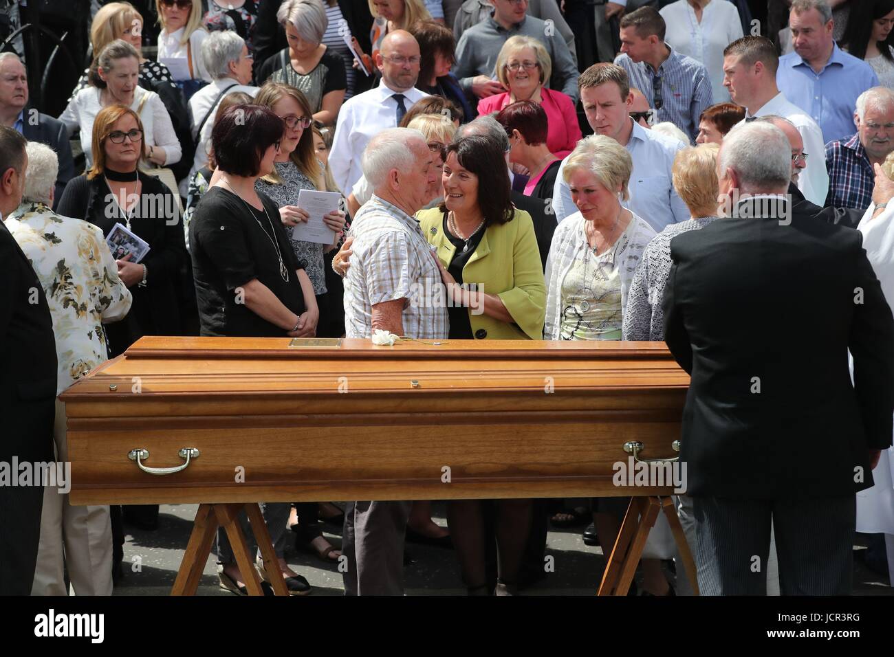 Seamus Ruddy's Sisiter Anne Morgan (centre) is comforted during his funeral at St Catherine's Dominican Chapel in Newry Co Armagh. Stock Photo