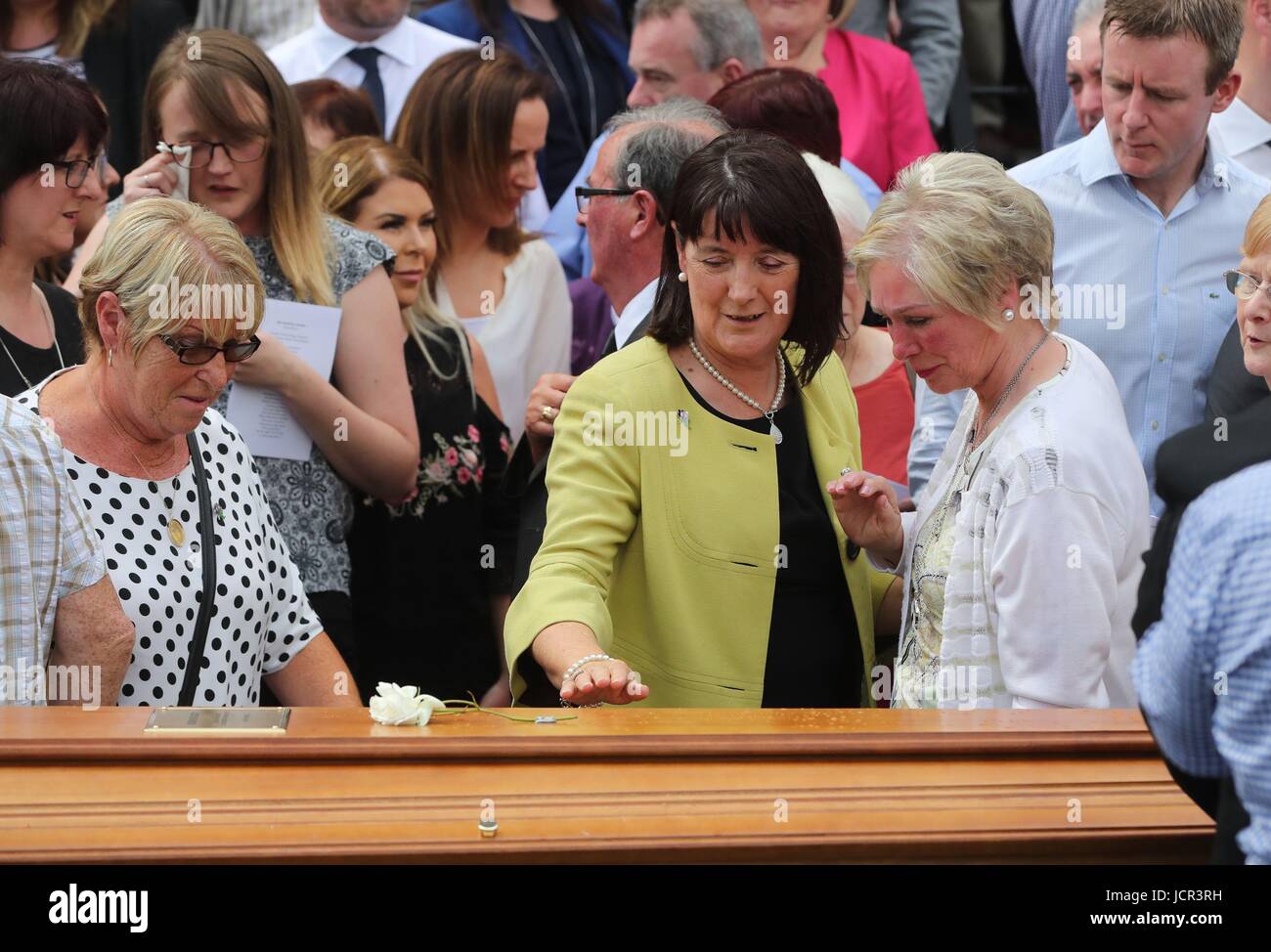 Seamus Ruddy's Sisiter Anne Morgan (centre) is comforted during his funeral at St Catherine's Dominican Chapel in Newry Co Armagh. Stock Photo