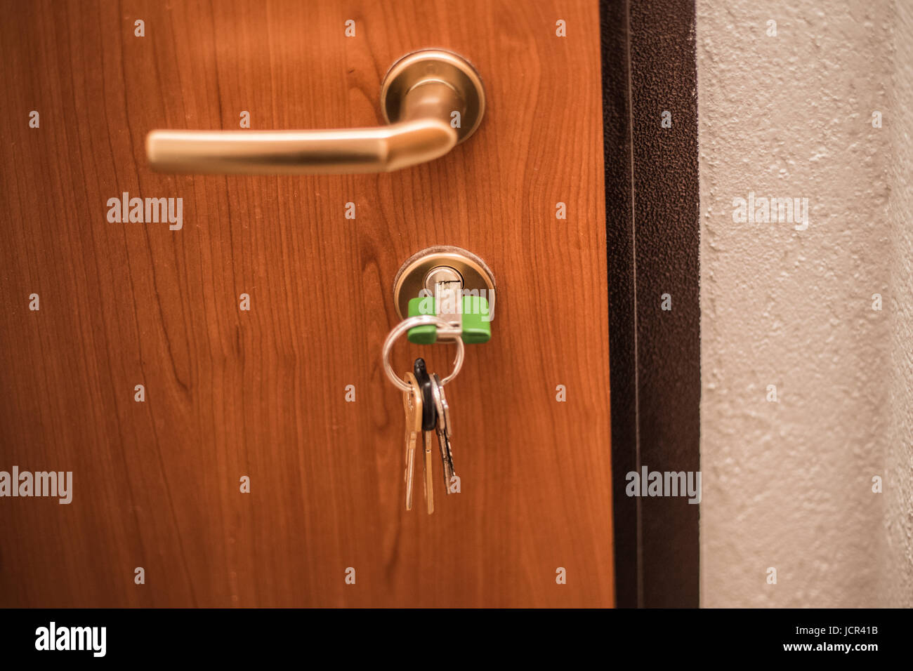 The keys in the lock of the door, away from home, lock the door, safety