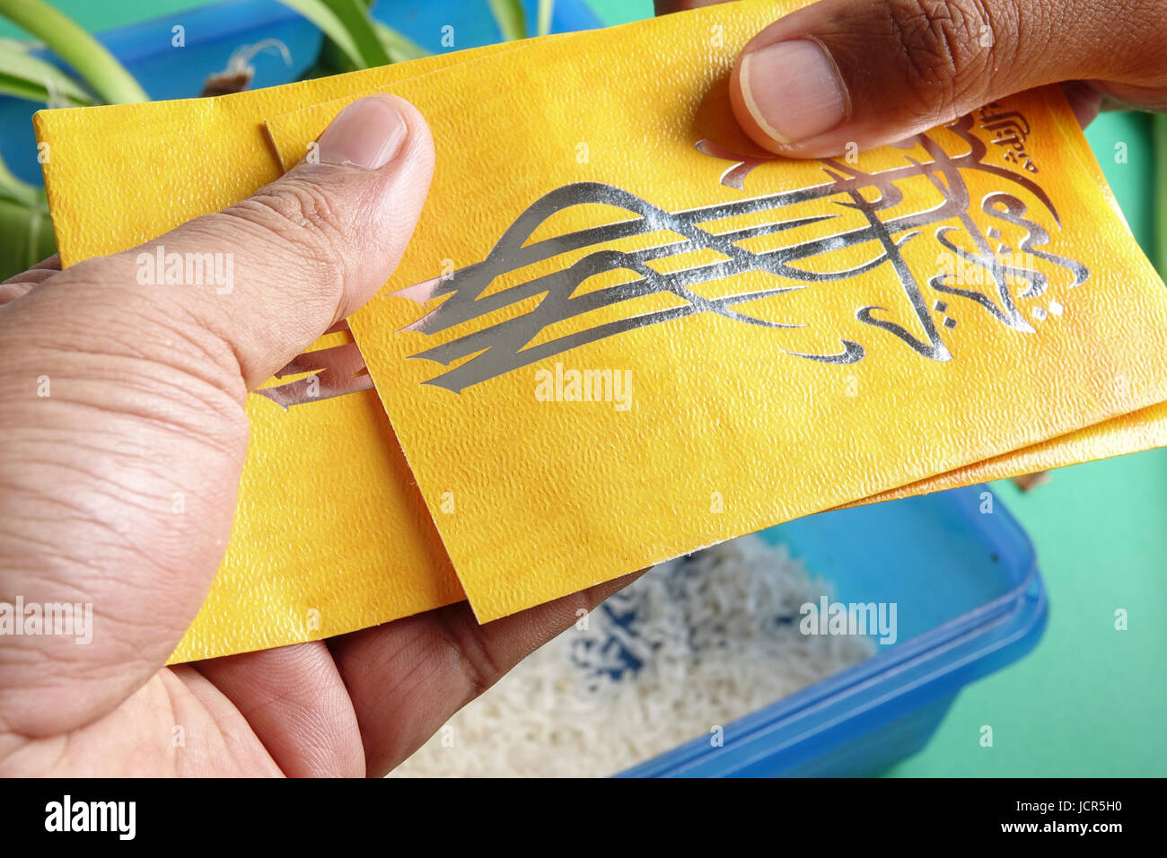 Giving and receiving money packet during Eid Fitri. Arabic character