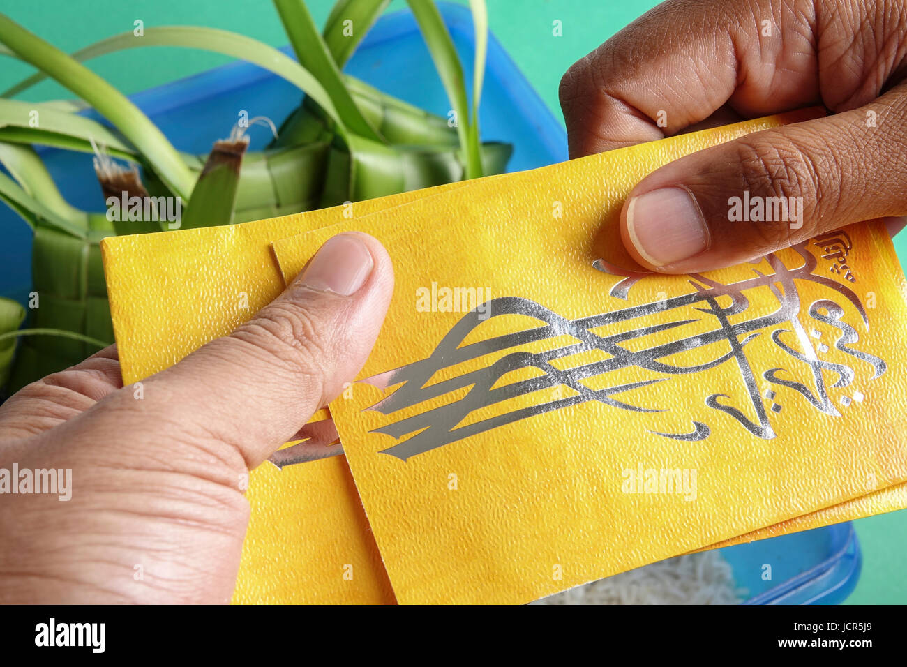 Giving and receiving money packet during Eid Fitri. Arabic character