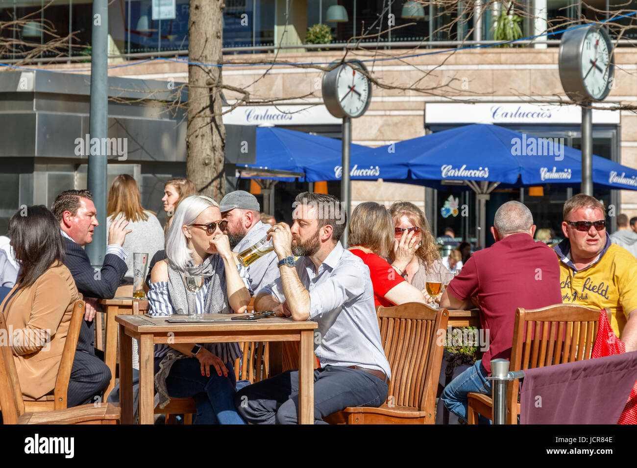 London, UK - May 10, 2017 - Reuters Plaza in Canary Wharf packed with people drinking on a sunny day Stock Photo