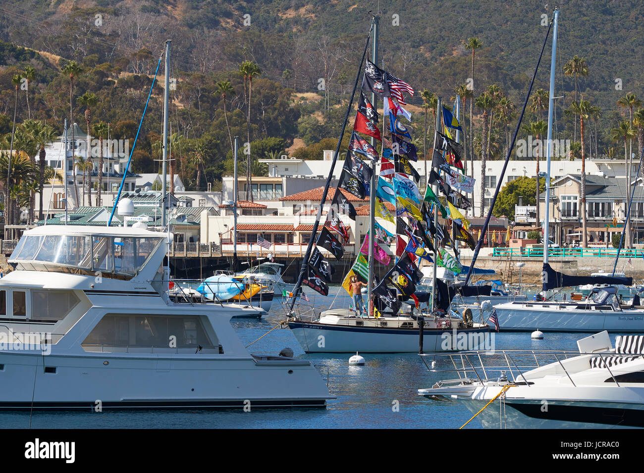 Sailing Boat With Many Flags Moored In Avalon Harbor, Catalina Island, California. Stock Photo