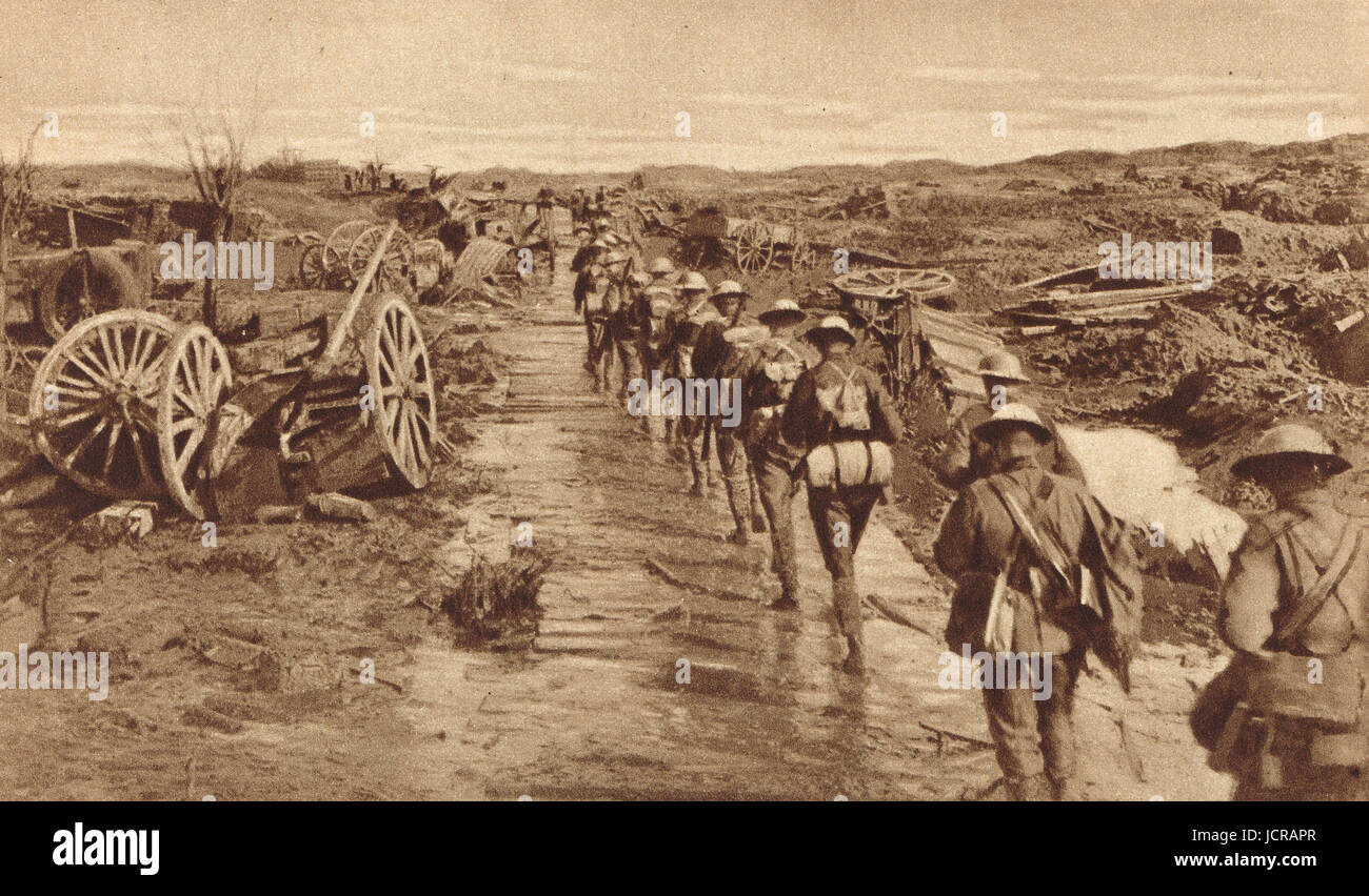 Australian infantry, in file on heavily  shelled road, on way to relieve the front, 1917 Stock Photo