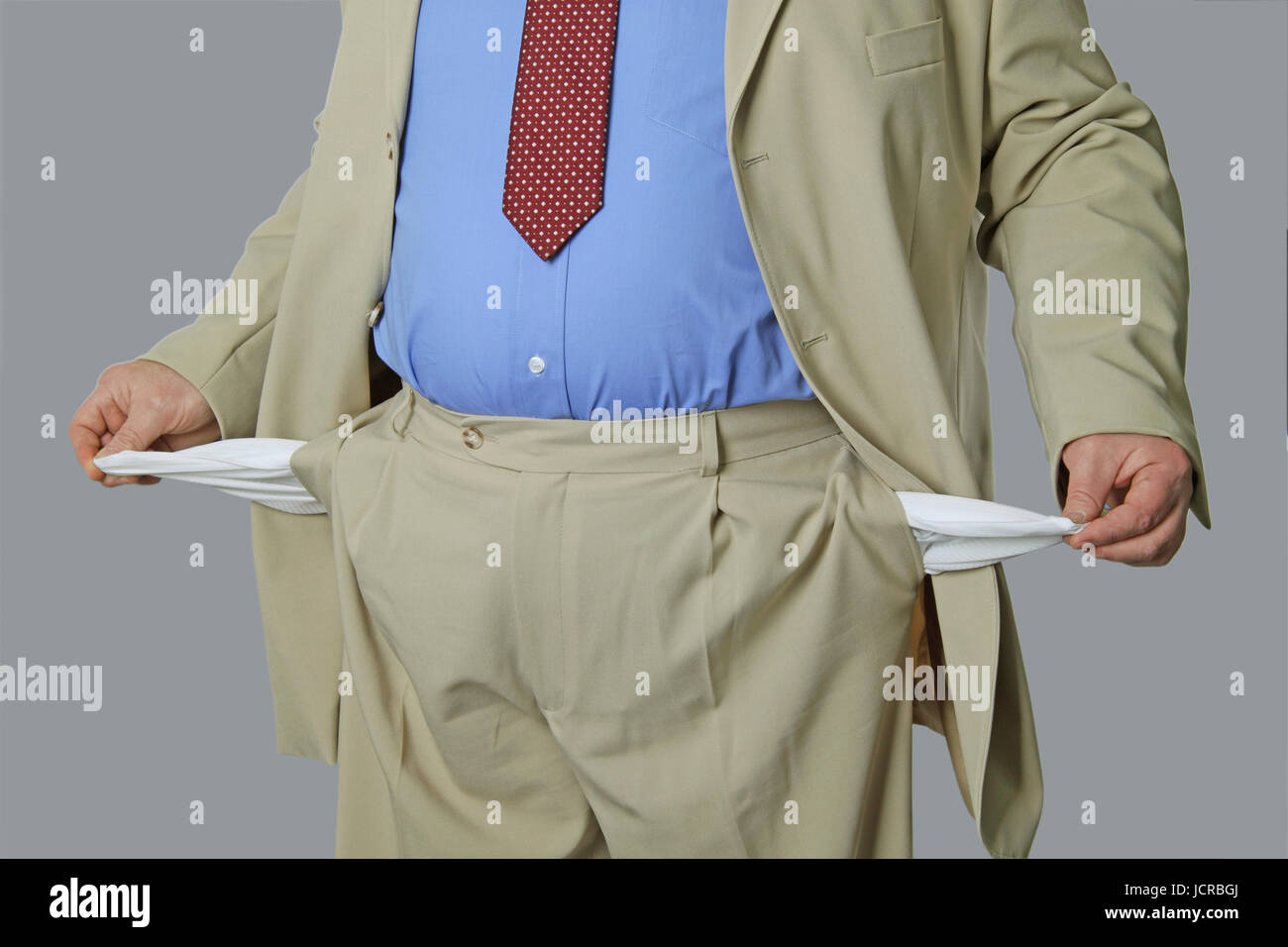Man shows empty bags on grey background Stock Photo - Alamy