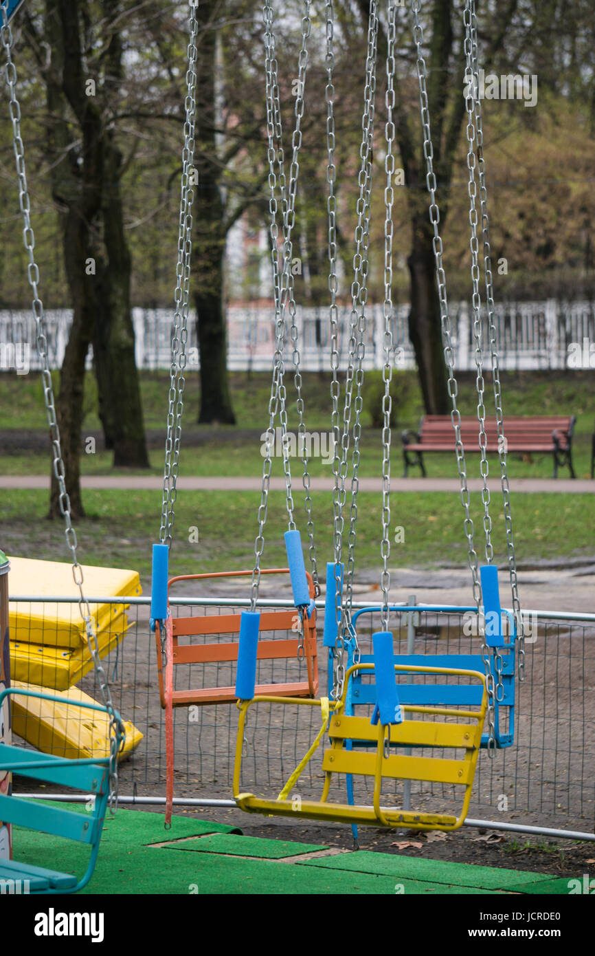 old roundabout carousel swing seats attraction for children at the