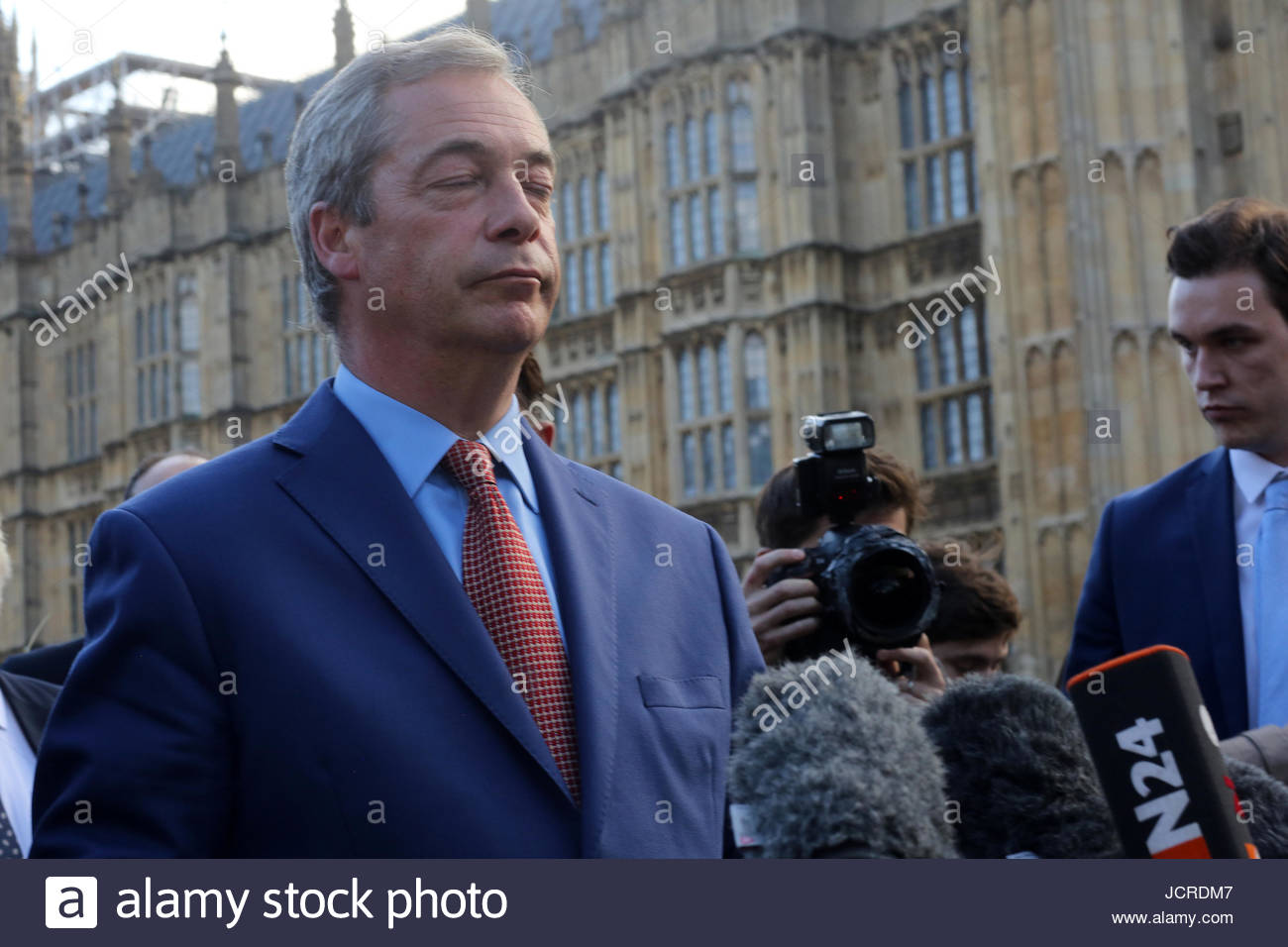 Nigel Farage closes his eyes for a moment before speaking to the world press on the morning after the Brexit referendum victory Stock Photo
