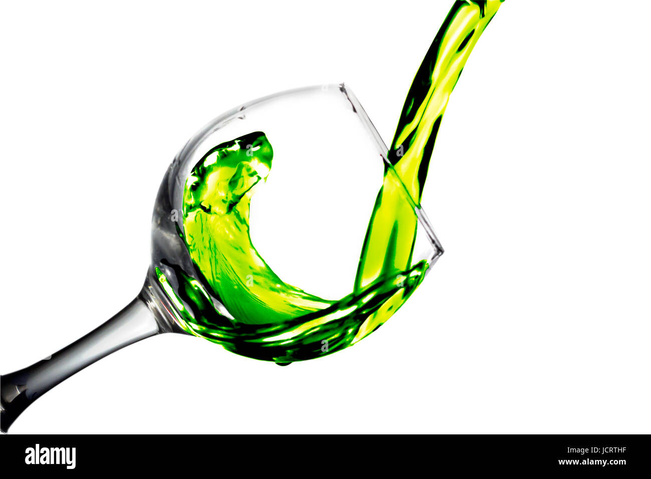Green liquid, water, blackberry juice pours into a glass, liquid in a speaker, isolated on a white background Stock Photo