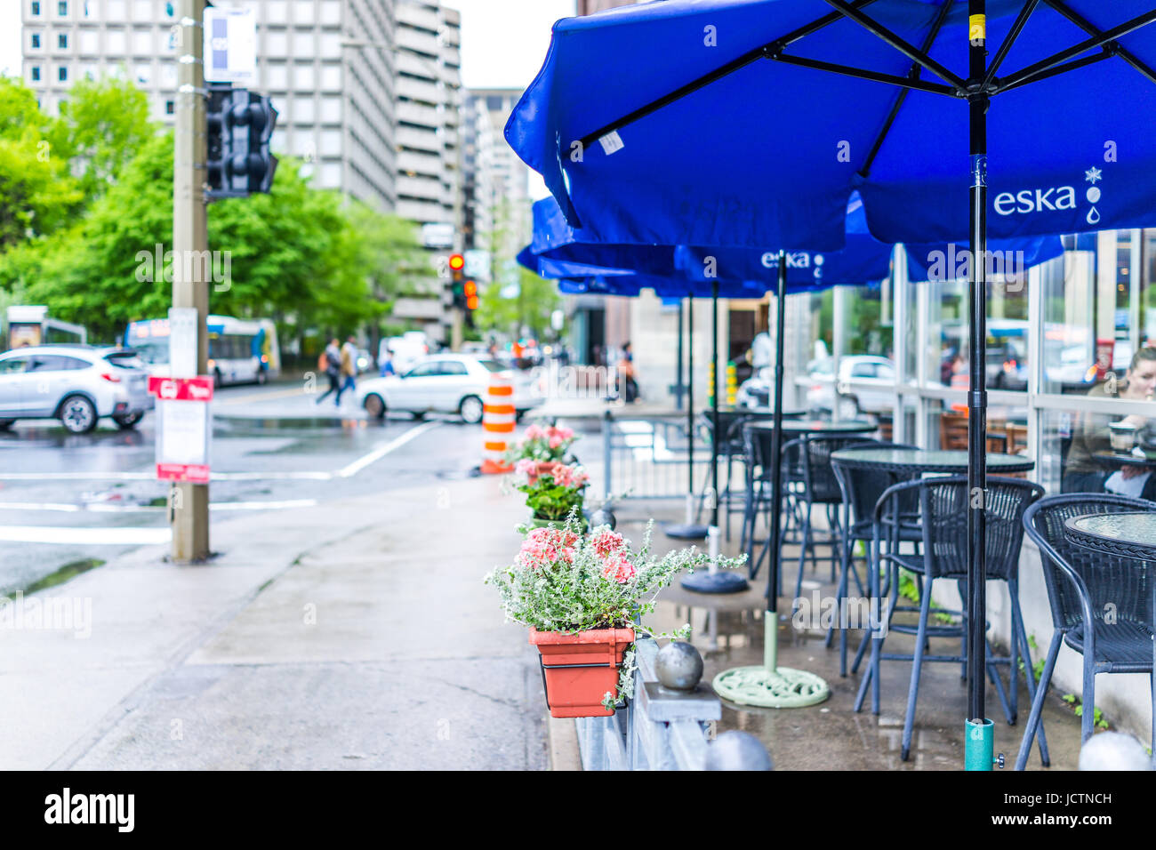 Montreal, Canada - May 26, 2017: Downtown area of city in Quebec region with restaurants and cafe with umbrella stands with Eska sign, outdoor patio t Stock Photo
