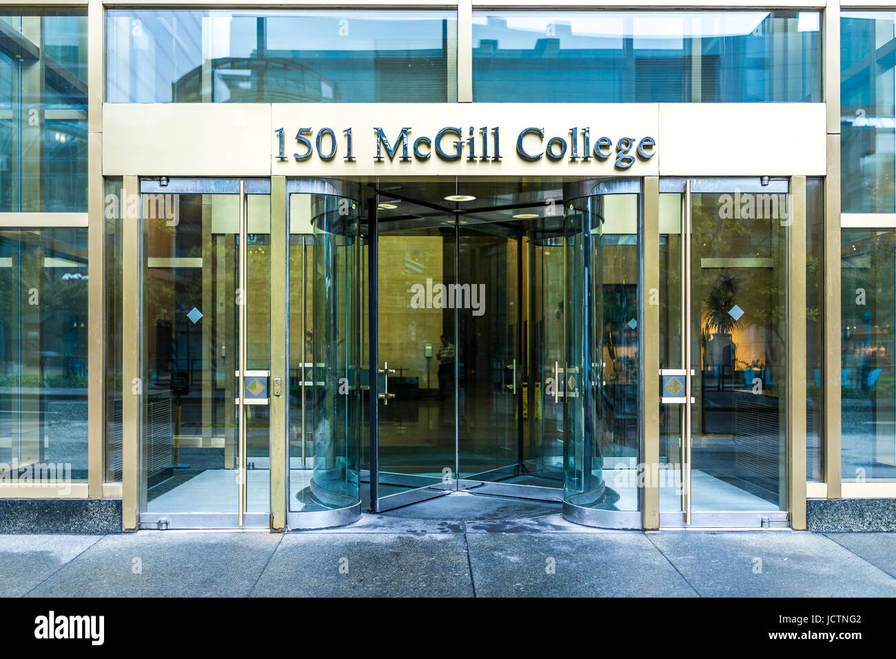 Montreal, Canada - May 26, 2017: McGill College University entrance with modern glass and gold door and sign in city in Quebec region Stock Photo