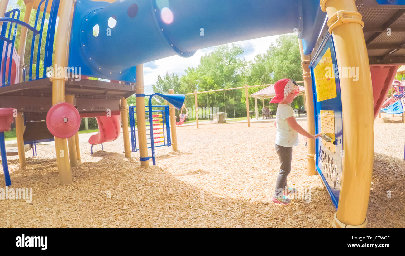 Little girl playing on the kids playground in the Summer Stock Photo ...