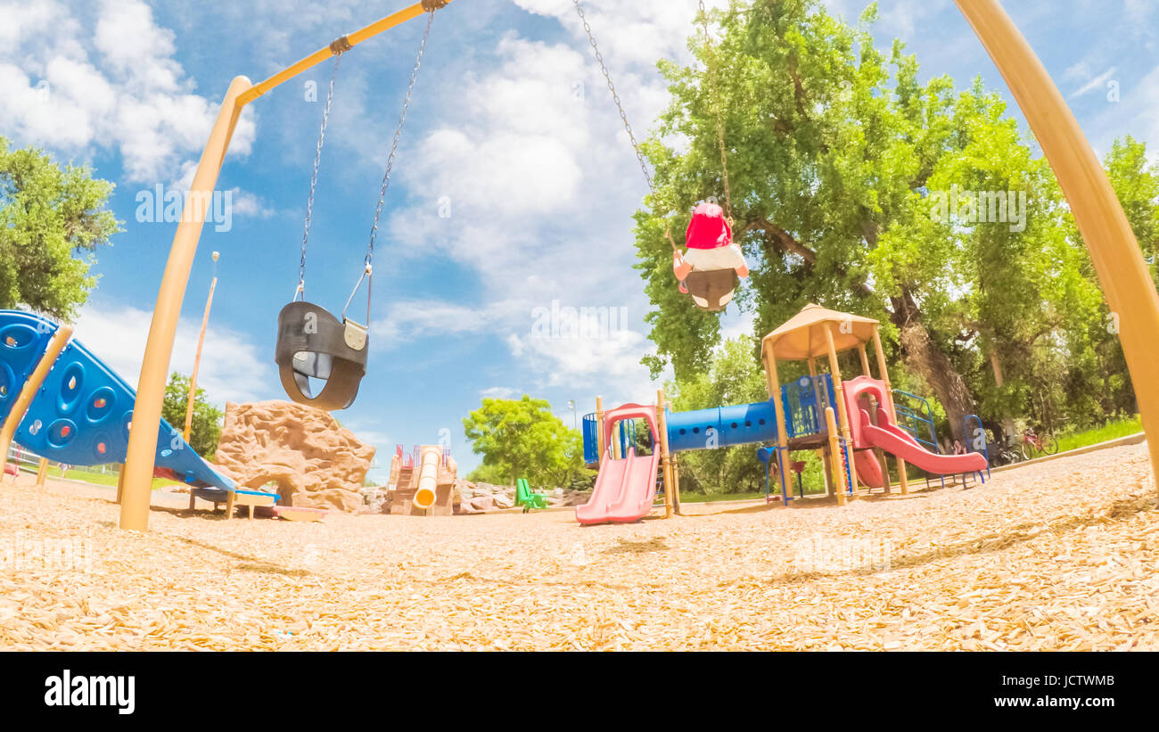 Little girl playing on the kids playground in the Summer Stock Photo ...