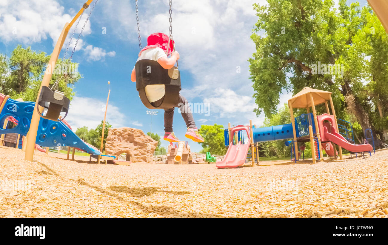 Little girl playing on the kids playground in the Summer Stock Photo ...