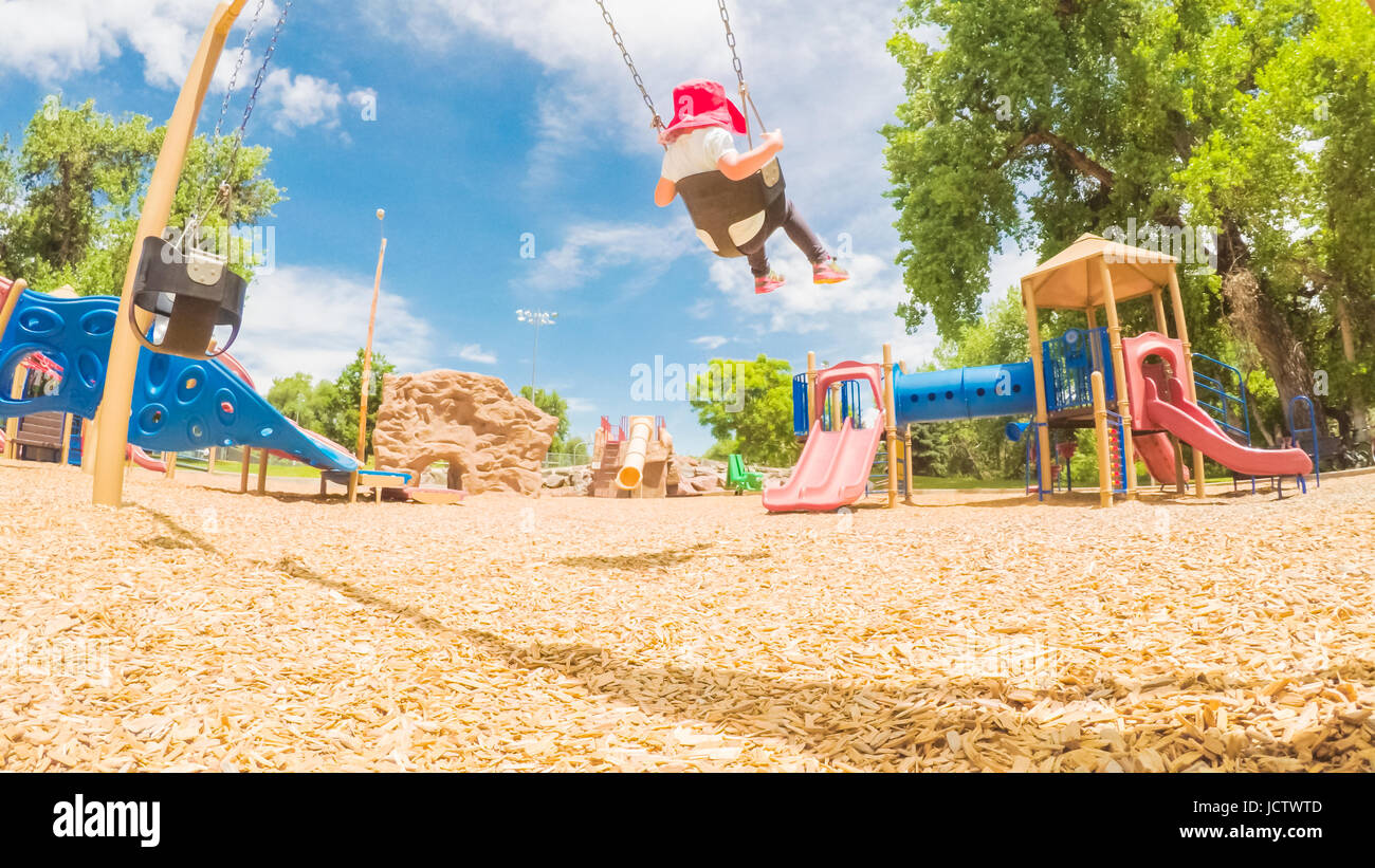Little girl playing on the kids playground in the Summer Stock Photo ...
