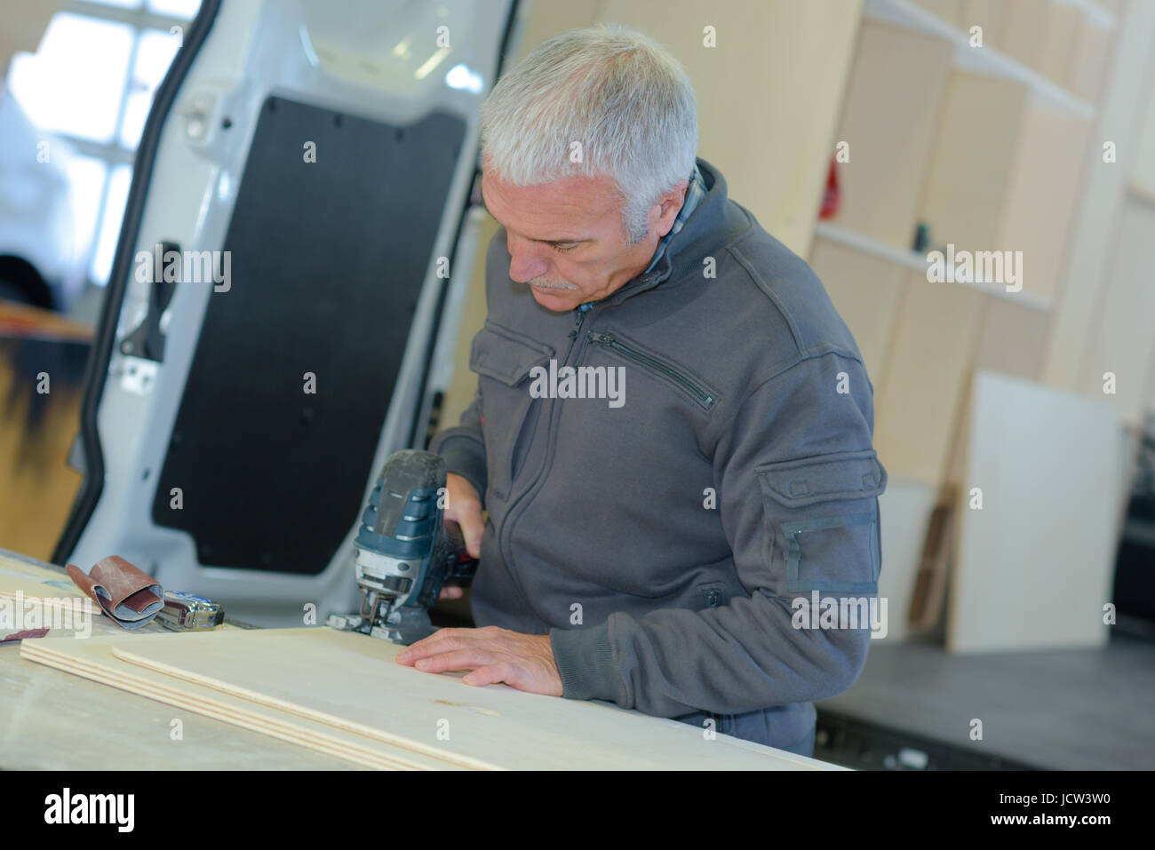 man cutting wood with circular saw Stock Photo - Alamy