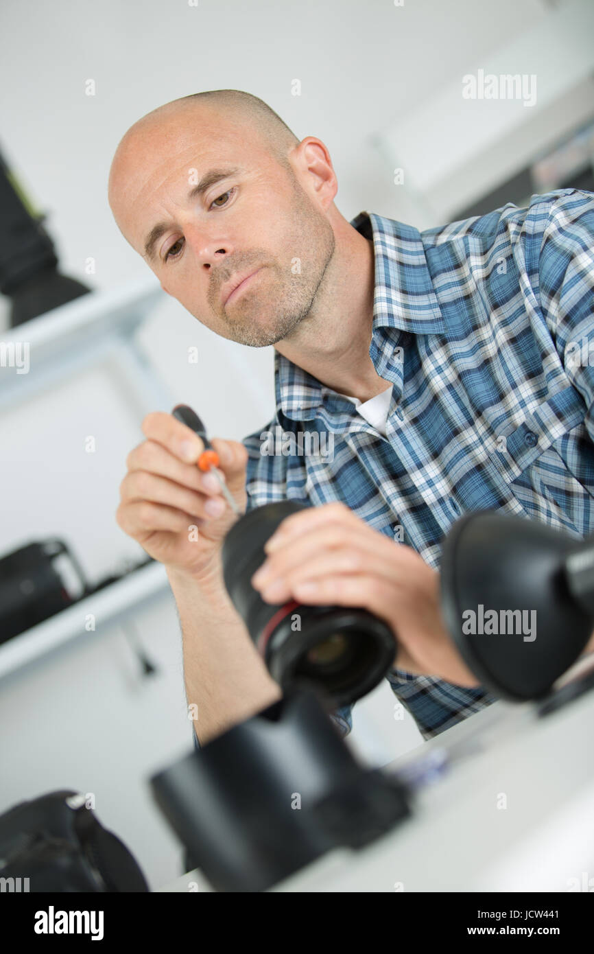 photographer changing his prime lens on camera Stock Photo Alamy