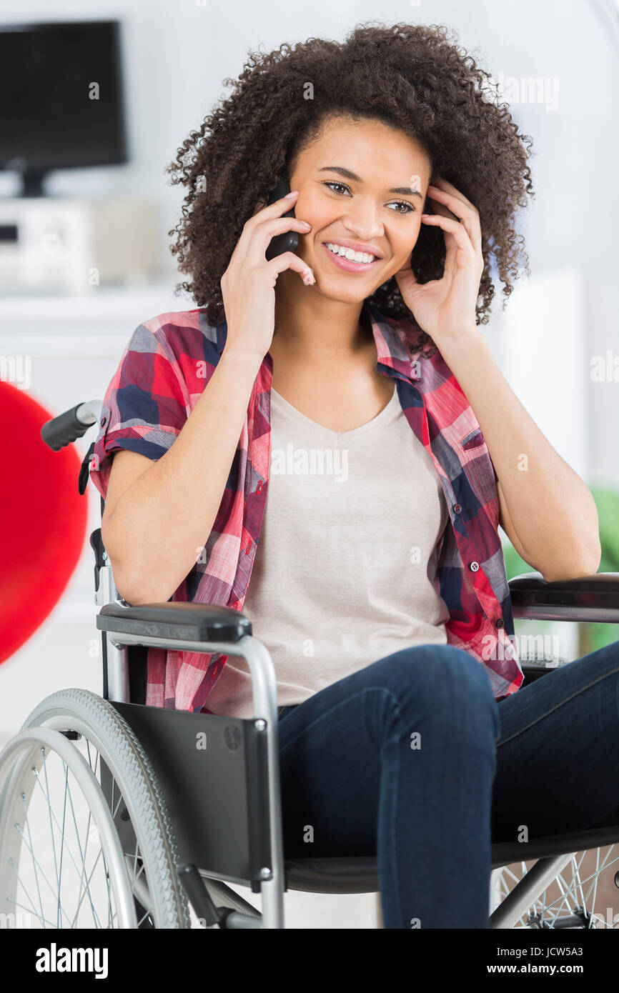 confident woman in wheelchair with her mobile phone Stock Photo - Alamy
