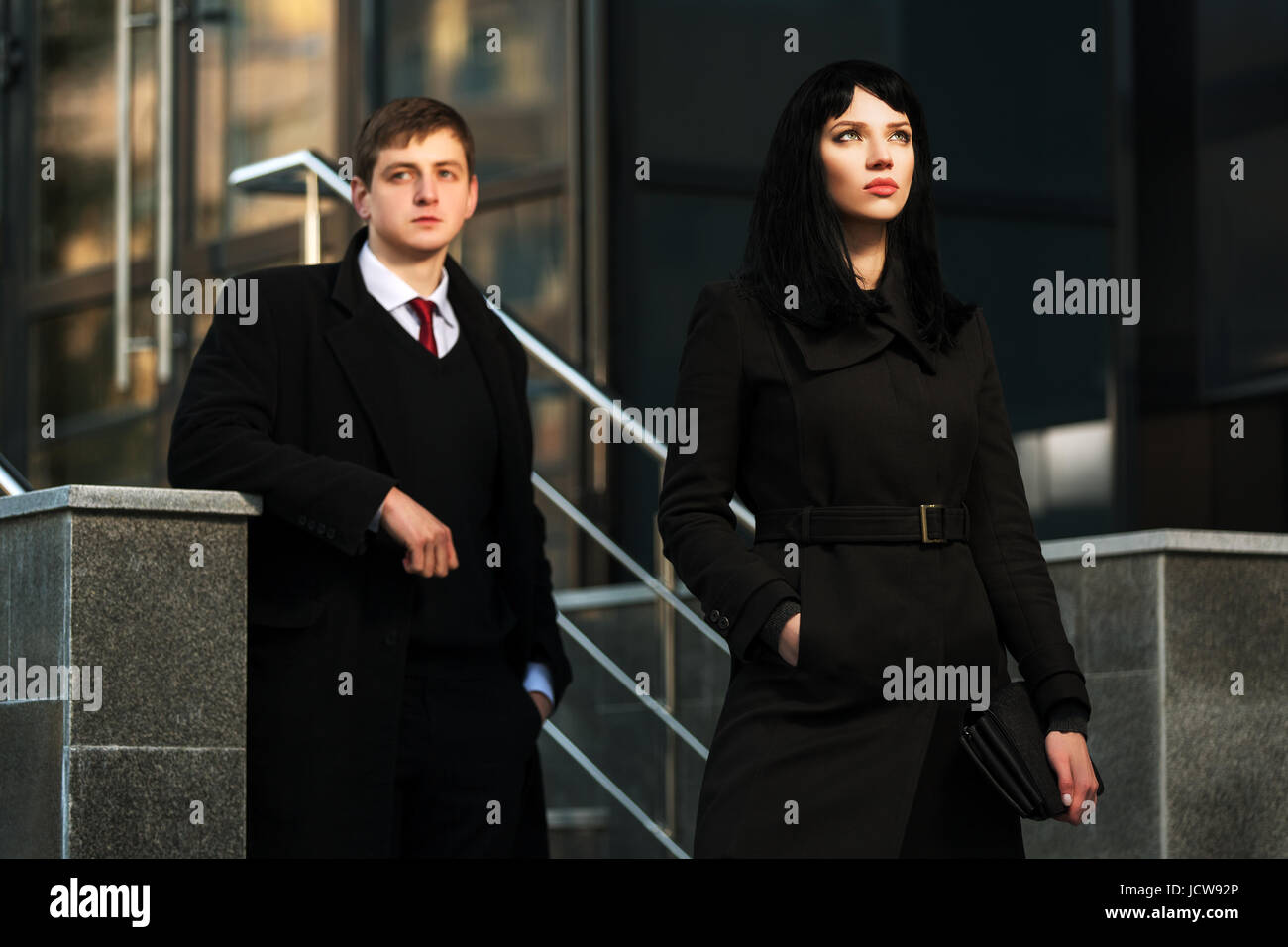 Young business couple against office building Stock Photo - Alamy