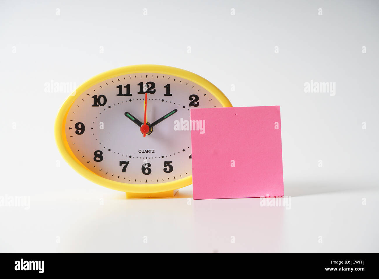 Time Notes Clock Yellow table clock with time management conceptual text on the note ...