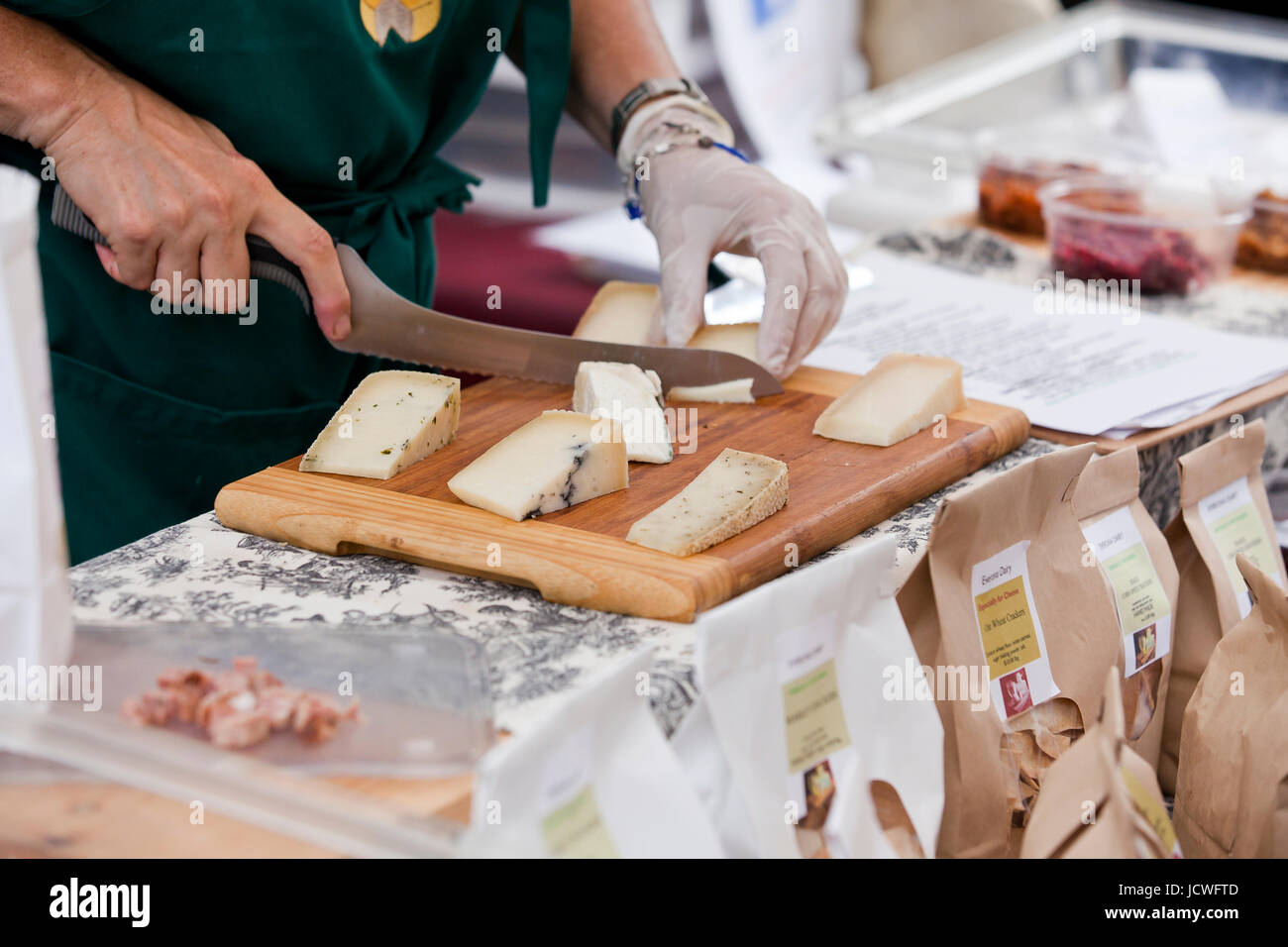 Man cutting various types of cheese - USA Stock Photo