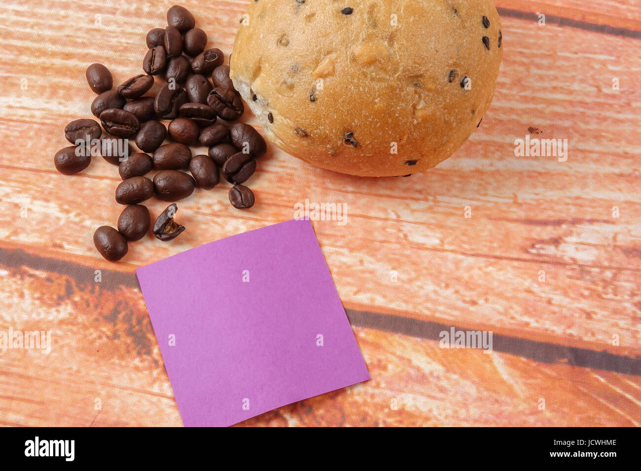 Morning breakfast concept with coffee,bun, post it notes on wooden ...