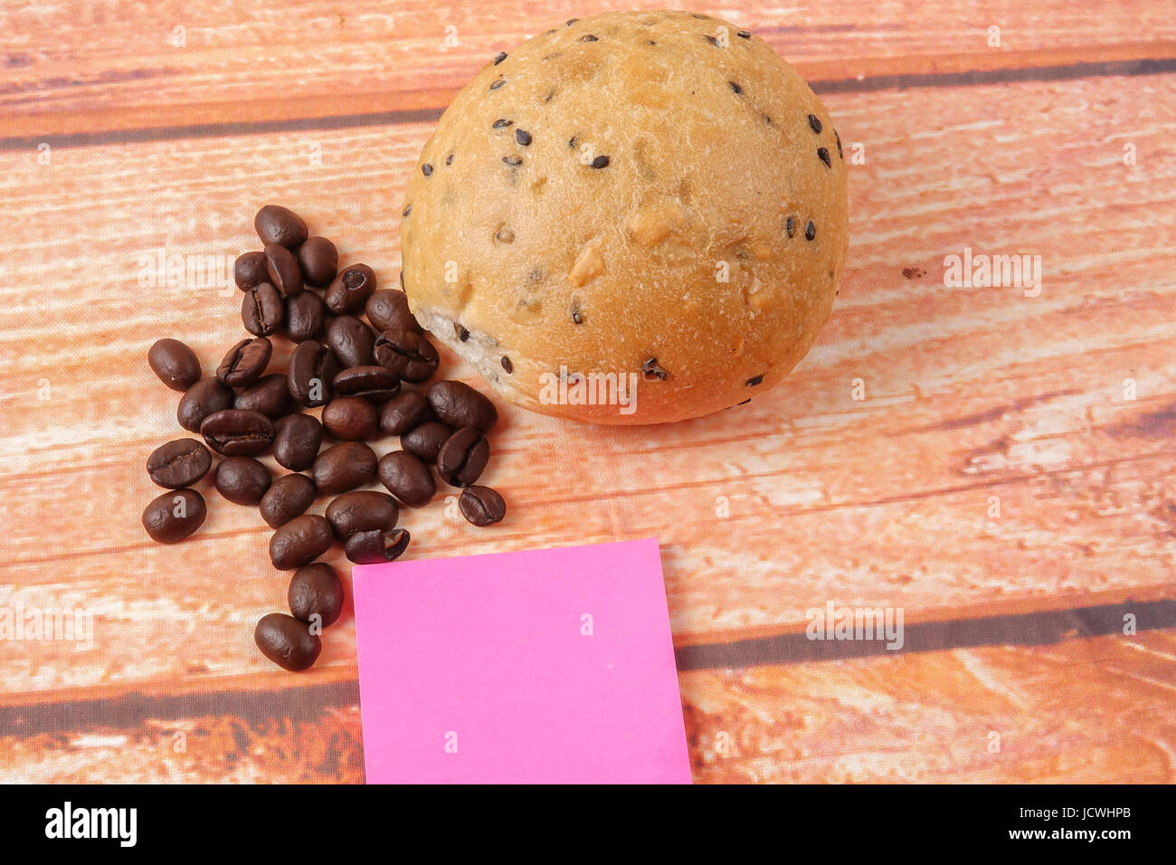 Morning breakfast concept with coffee,bun, post it notes on wooden ...