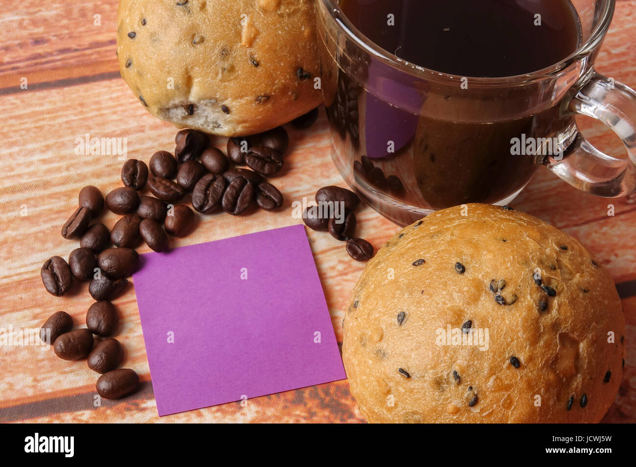 Morning breakfast concept with coffee,bun, post it notes on wooden ...