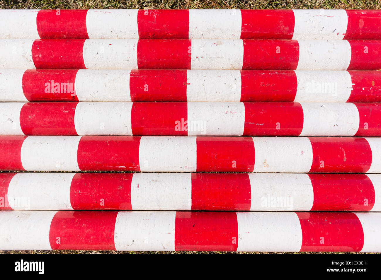 Wood poles red white painted together equestrian show jumping equipment Stock Photo