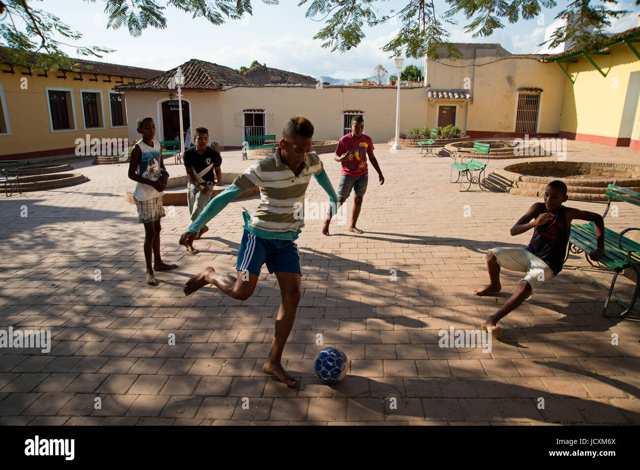 Young Cuban boys playing football in the streets of Trinidad Cuba Stock Photo