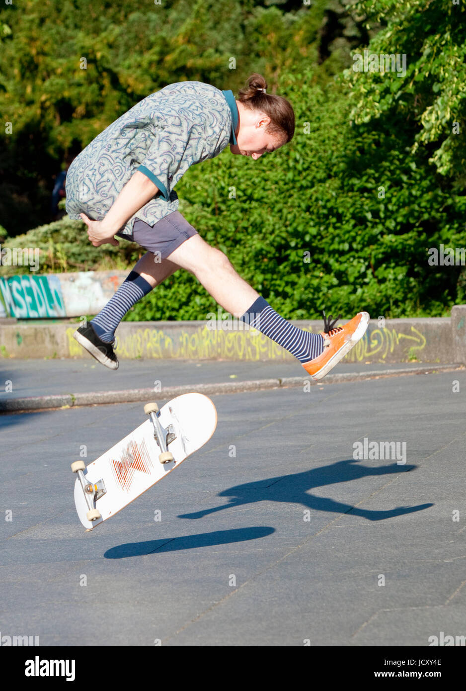 Skateboarding - Skater jumping on  skateboard.. Stock Photo