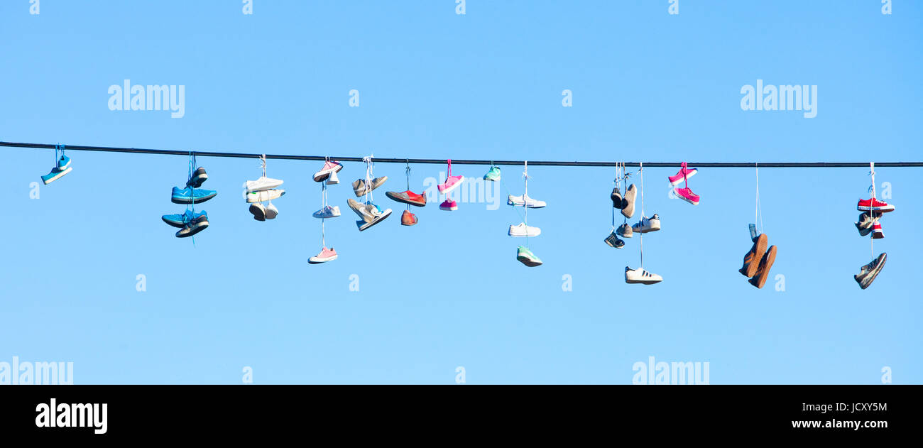 Shoes hanging from power line Stock Photo Alamy