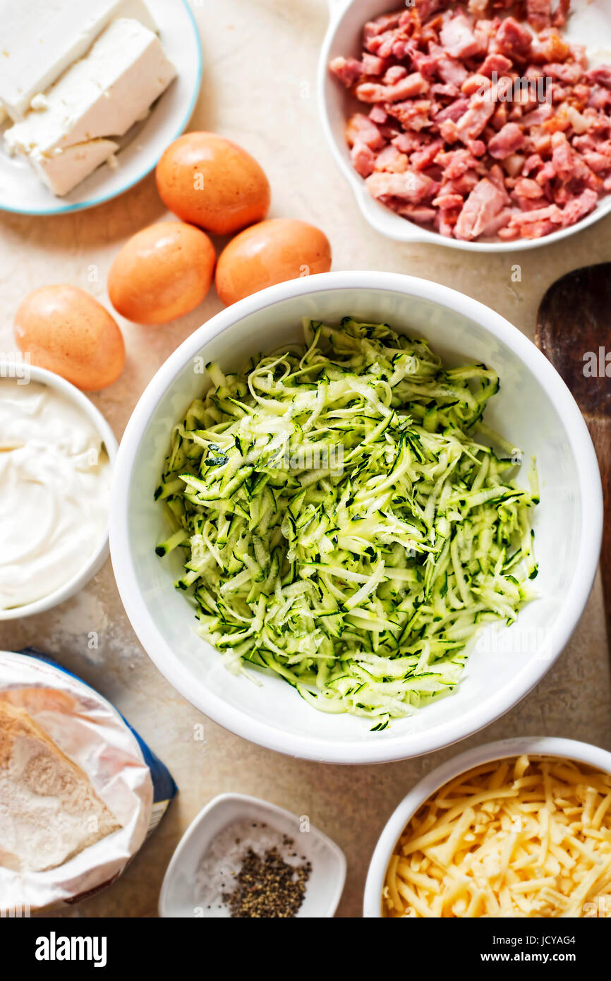 Courgette cake (frittata) ingredients mixed in white bowl eggs, flour