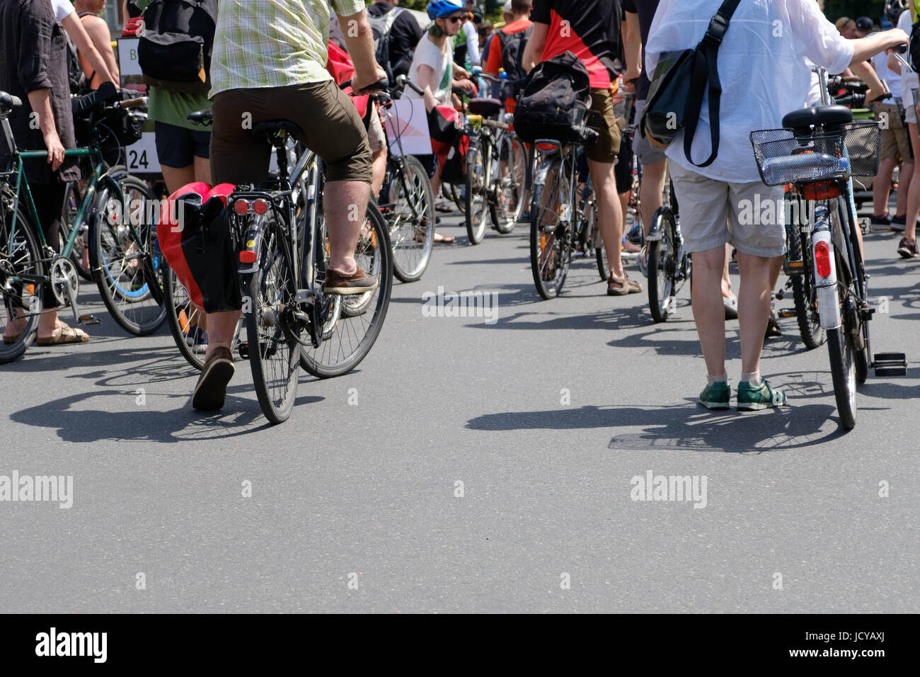 Many people on bicycles on on street from behind Stock Photo