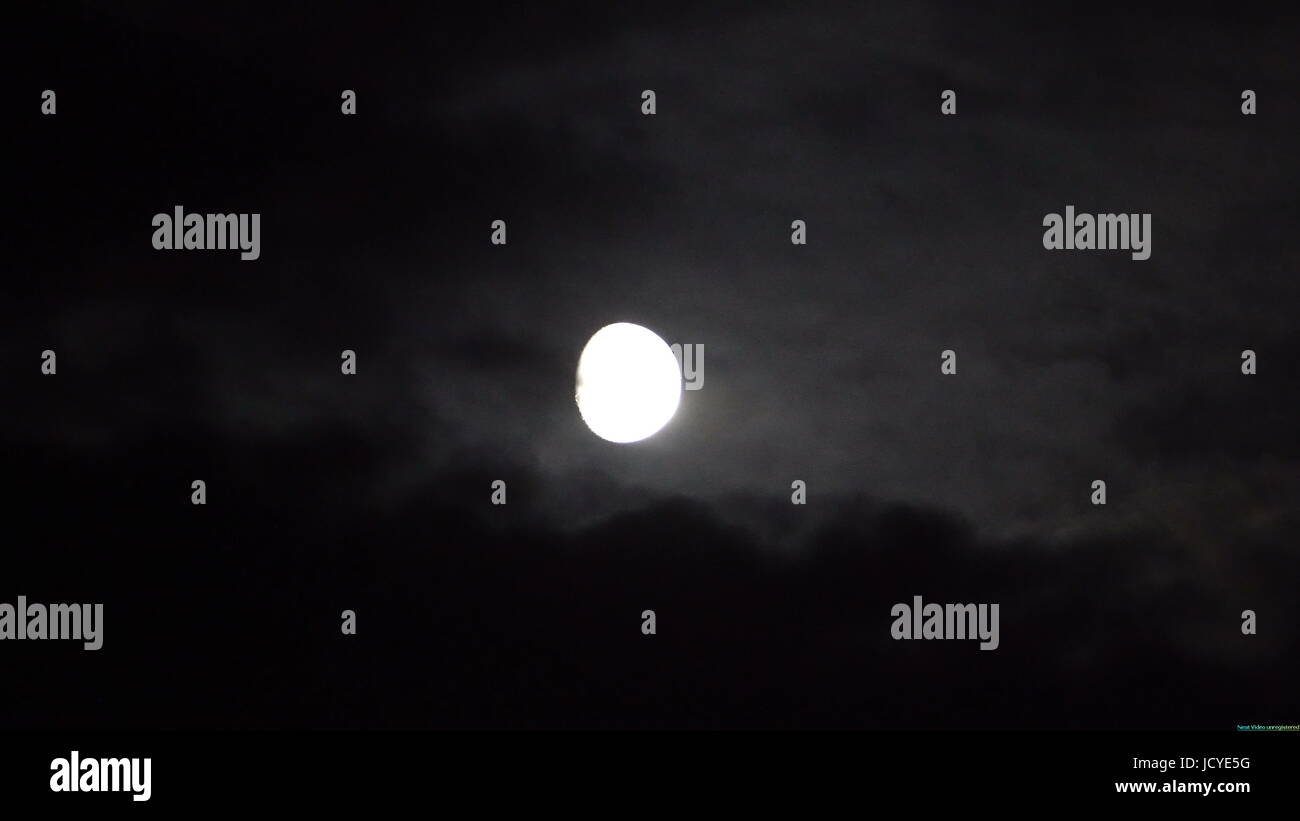 Full moon behind clouds at night Stock Photo Alamy