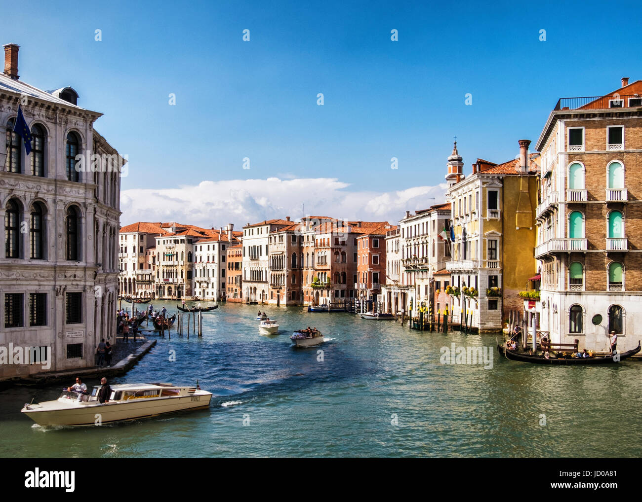 Venice, San Marco.Grand Canal, Typical Venetian landscape view with weathered houses and grand palazzos,church steeple,water taxis and gondolas Stock Photo