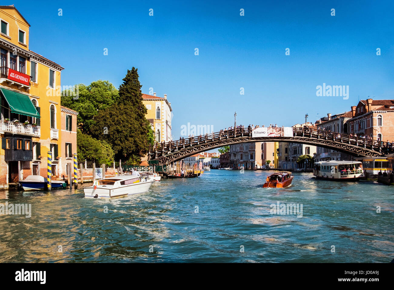 Italy, Venice, San Marco. Grand canal view,Ponte dell'Accademia,People crossing the Accademia Bridge, houses,water bus and water taxis Stock Photo