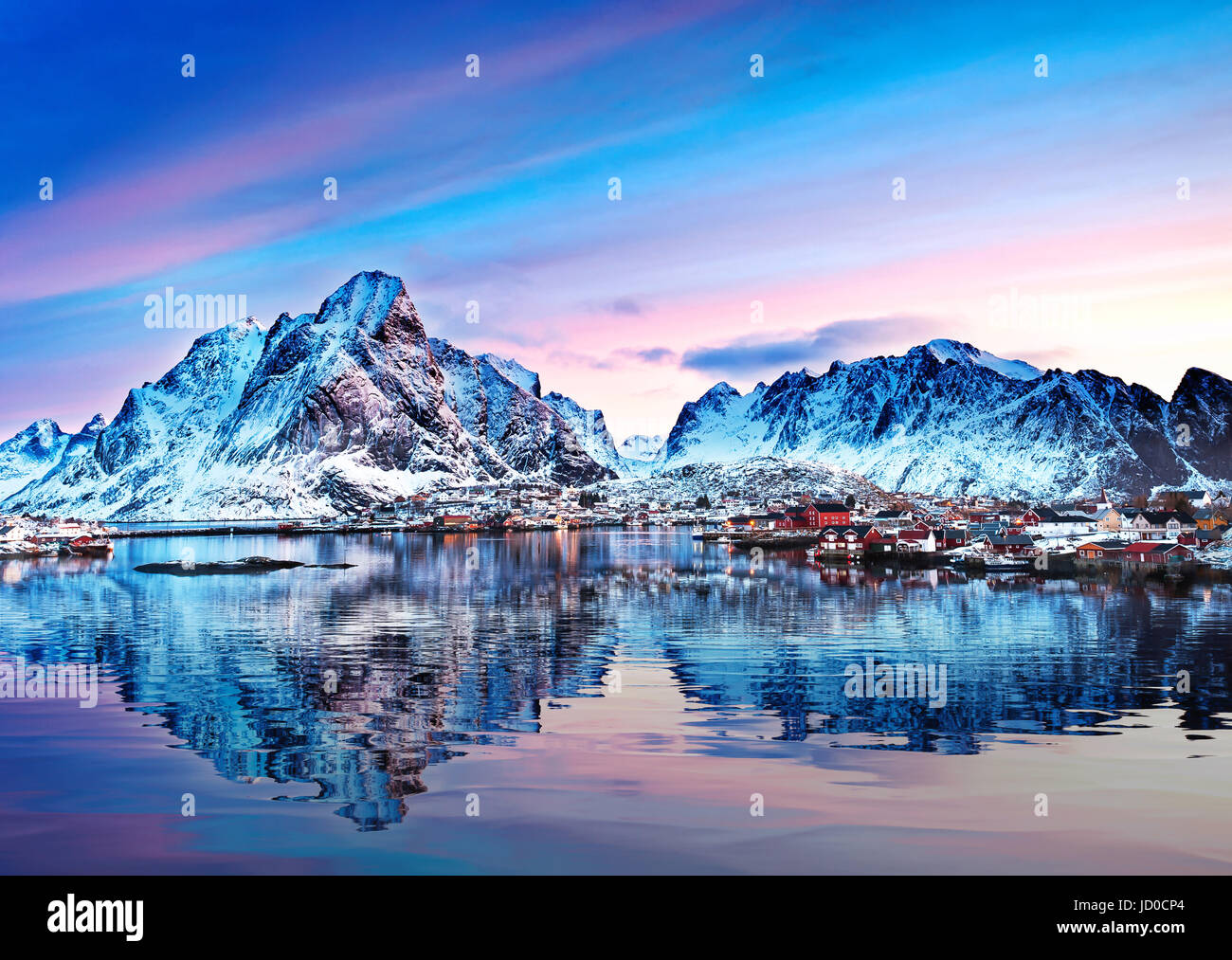 Mount Olstind reflected in the calm waters of Reinfjord on the Lofoten Islands Stock Photo