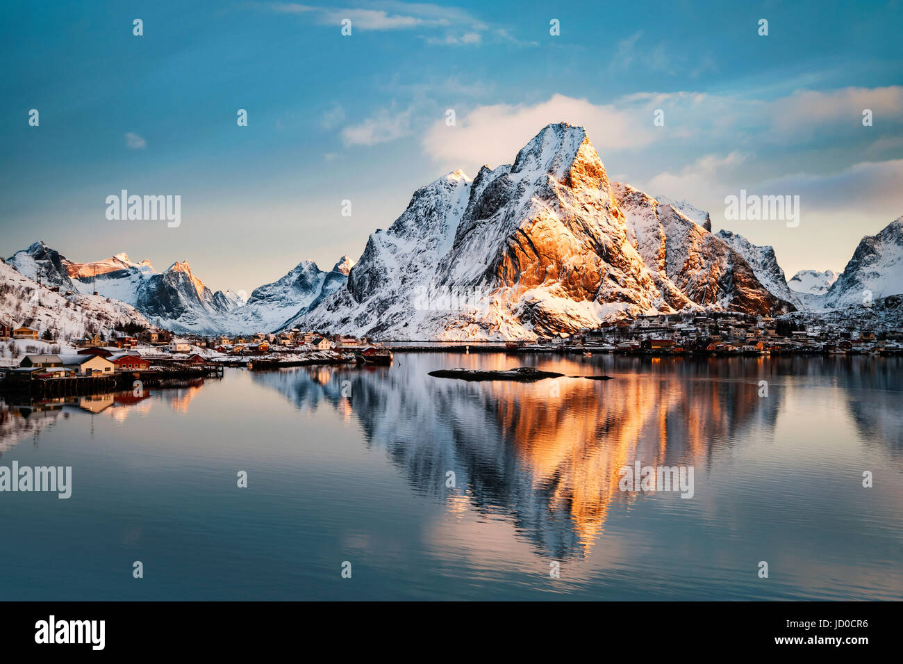 Mount Olstind reflected in the calm waters of Reinfjord on the Lofoten Islands Stock Photo