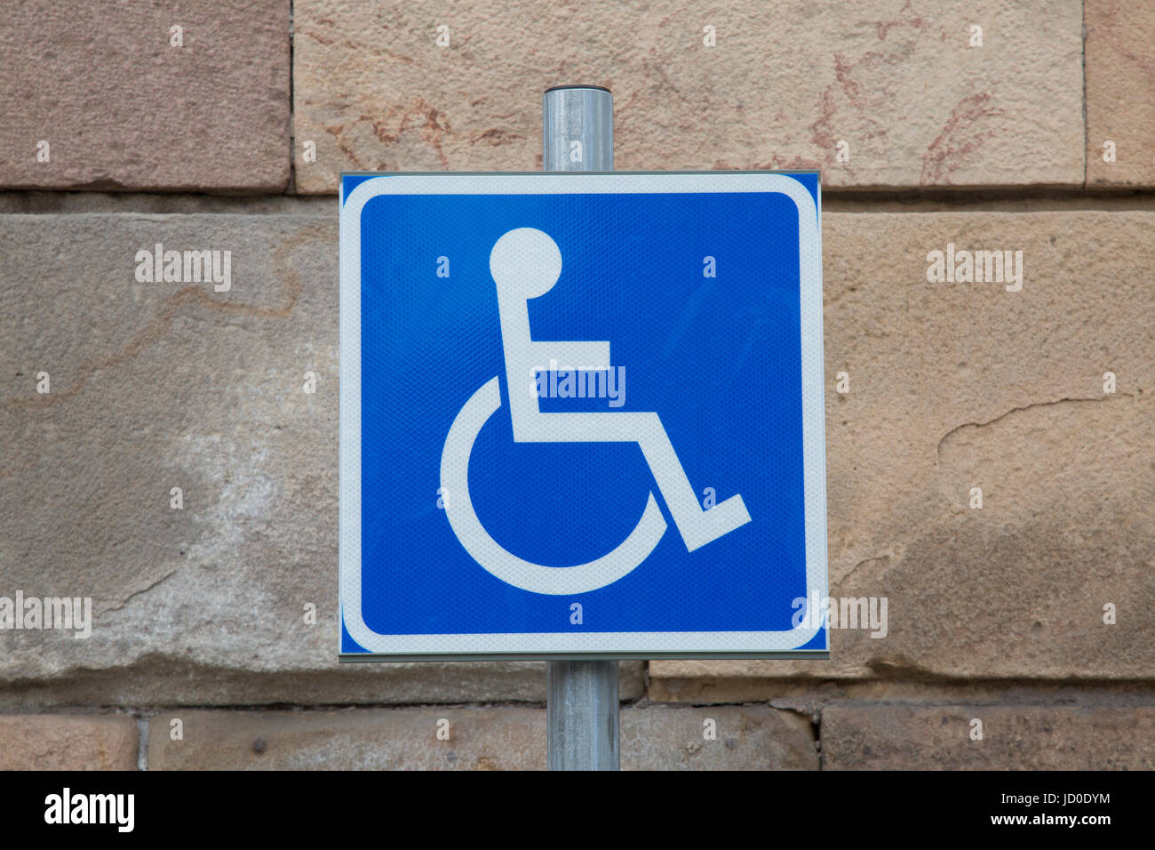 Disabled Parking Sign against Stone Wall Stock Photo - Alamy