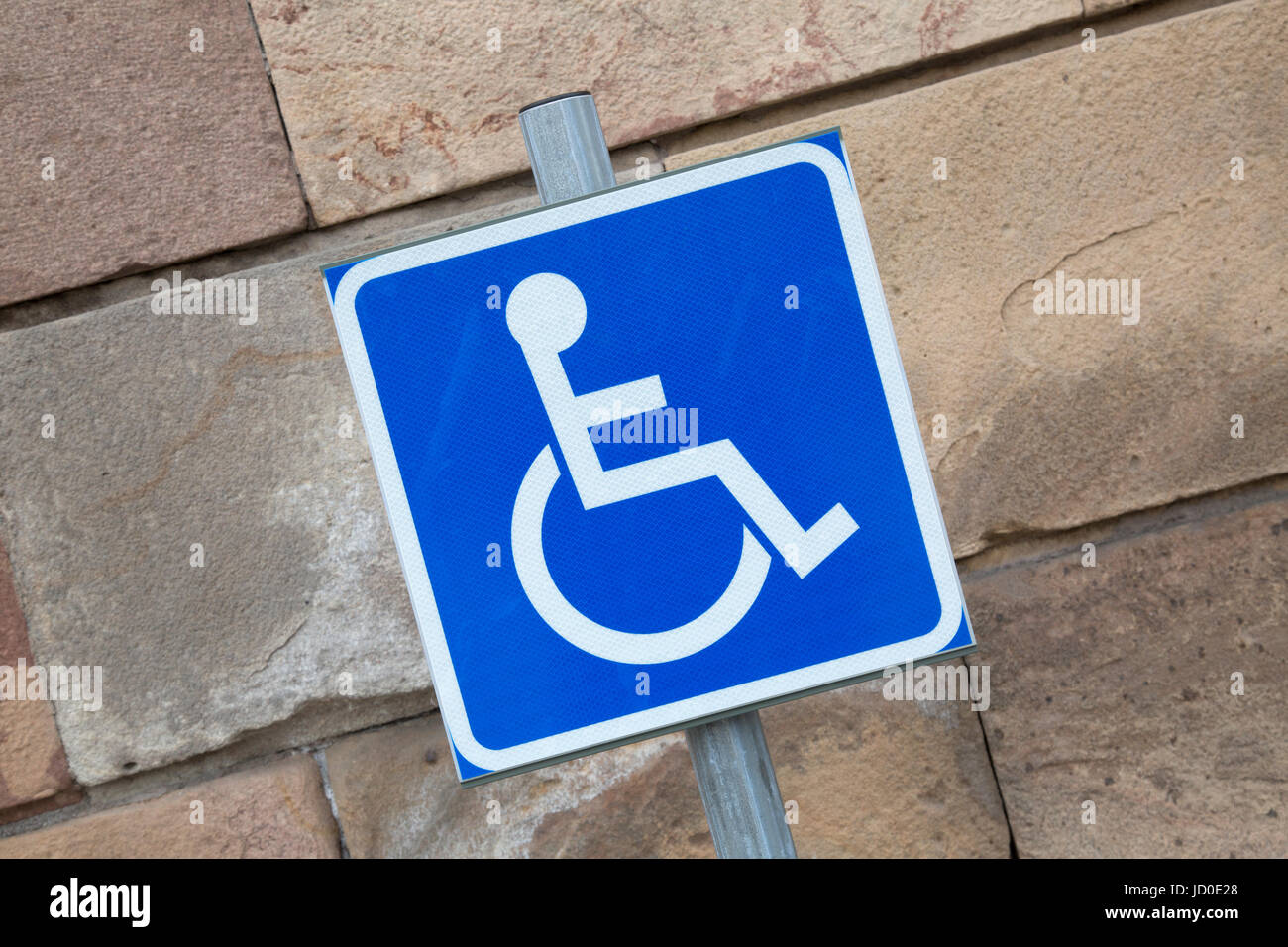 Disabled Parking Sign against Stone Wall Stock Photo - Alamy