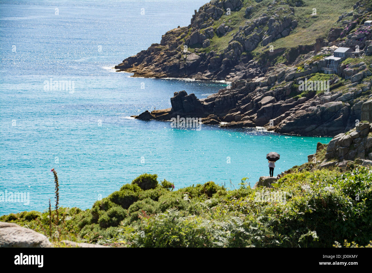 Treen, Cornwall, UK. 17th June, 2017. UK Weather. Some people were stripping off today in the blistering heat in Cornwall, some were covering up, and others were just enjoying the caribbean like sea at Treen. Credit: cwallpix/Alamy Live News Stock Photo