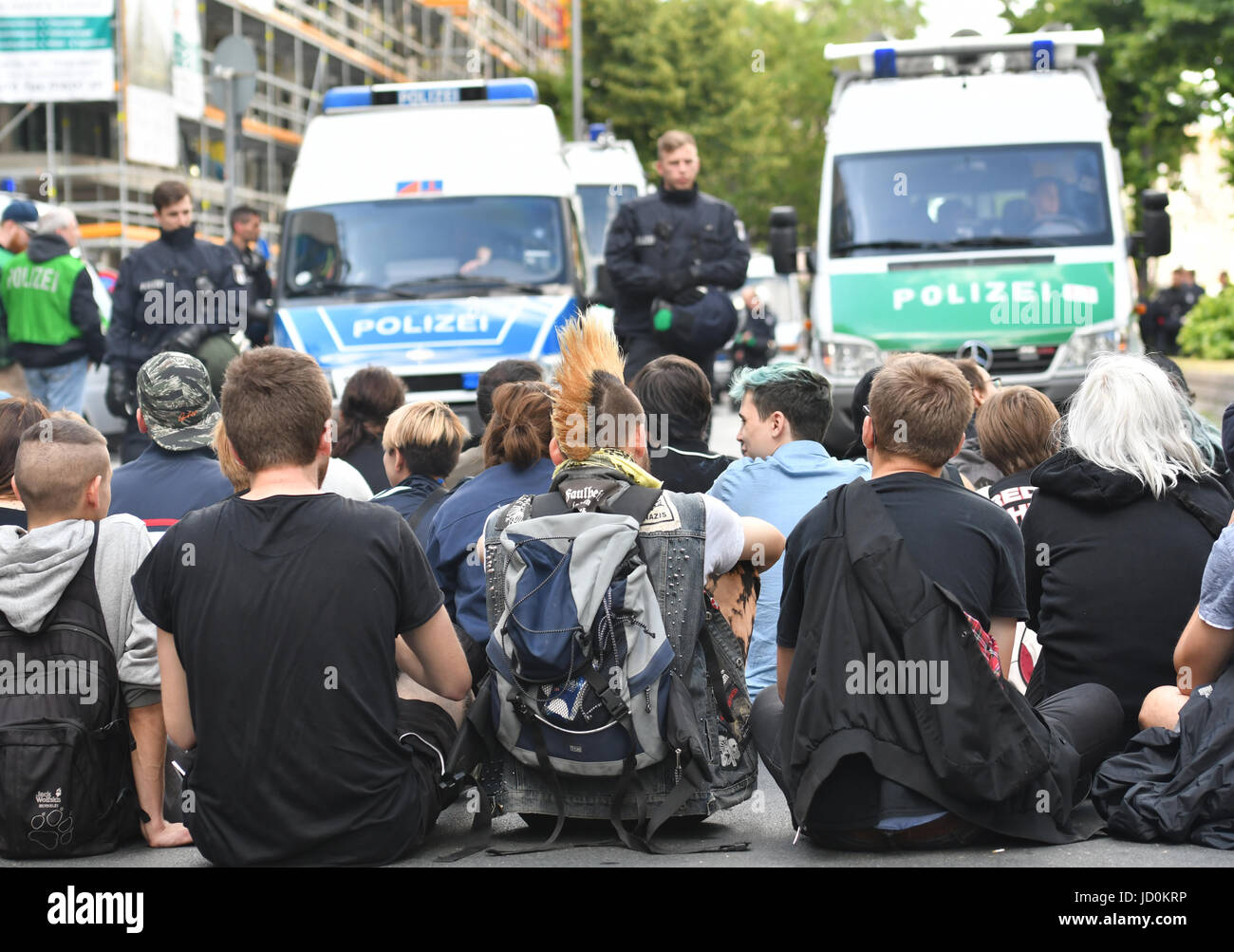 Berlin, Germany. 17th June, 2017. People sitting in the road blocking the passage of the 'Identitaere Bewegung' (lit. identitarian movement) in Berlin, Germany, 17 June 2017. Various groups protested against a demonstration by the right-wing group. Photo: Paul Zinken/dpa/Alamy Live News Stock Photo