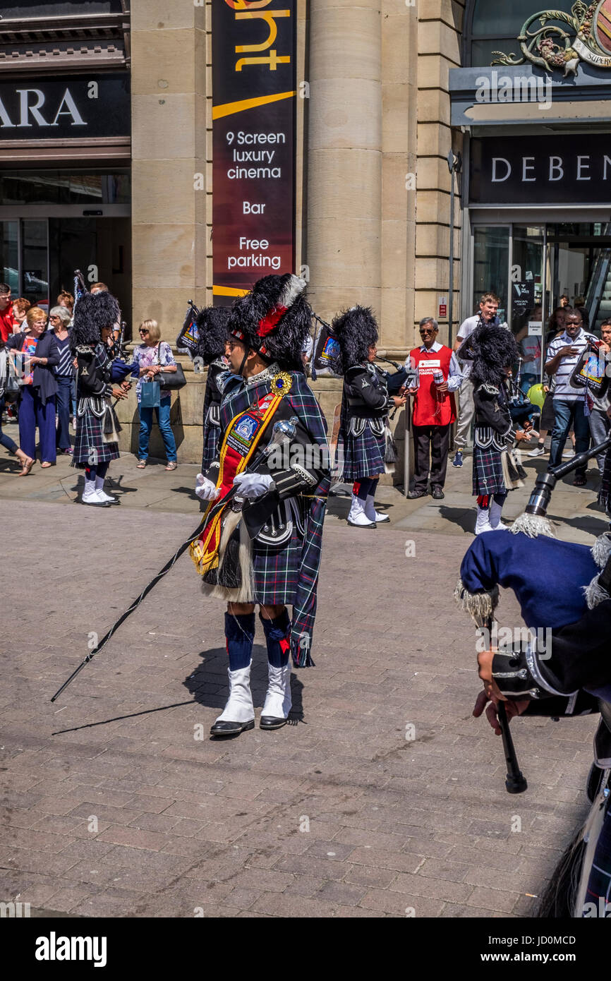 Bolton, Greater Manchester, UK. 17th June, 2017. The Shree Swaminaryan Gadi pipe band marching and playing the pipes and drums through Bolton Town Centre in aid of the We Love Manchester and the Red Cross, collecting donations to help the victims and families of the Manchester Bombing and other charities around the world. Credit: Mike Hesp/Alamy Live News Stock Photo