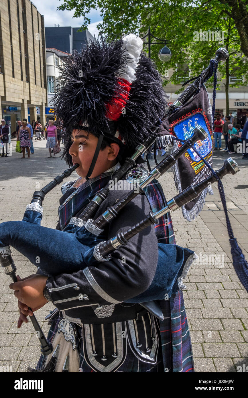 Bolton, Greater Manchester, UK. 17th June, 2017. The Shree Swaminaryan Gadi pipe band marching and playing the pipes and drums through Bolton Town Centre in aid of the We Love Manchester and the Red Cross, collecting donations to help the victims and families of the Manchester Bombing and other charities around the world. Credit: Mike Hesp/Alamy Live News Stock Photo