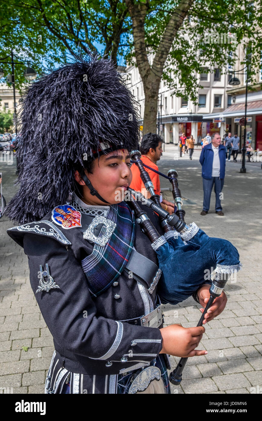 Bolton, Greater Manchester, UK. 17th June, 2017. The Shree Swaminaryan Gadi pipe band marching and playing the pipes and drums through Bolton Town Centre in aid of the We Love Manchester and the Red Cross, collecting donations to help the victims and families of the Manchester Bombing and other charities around the world. Credit: Mike Hesp/Alamy Live News Stock Photo