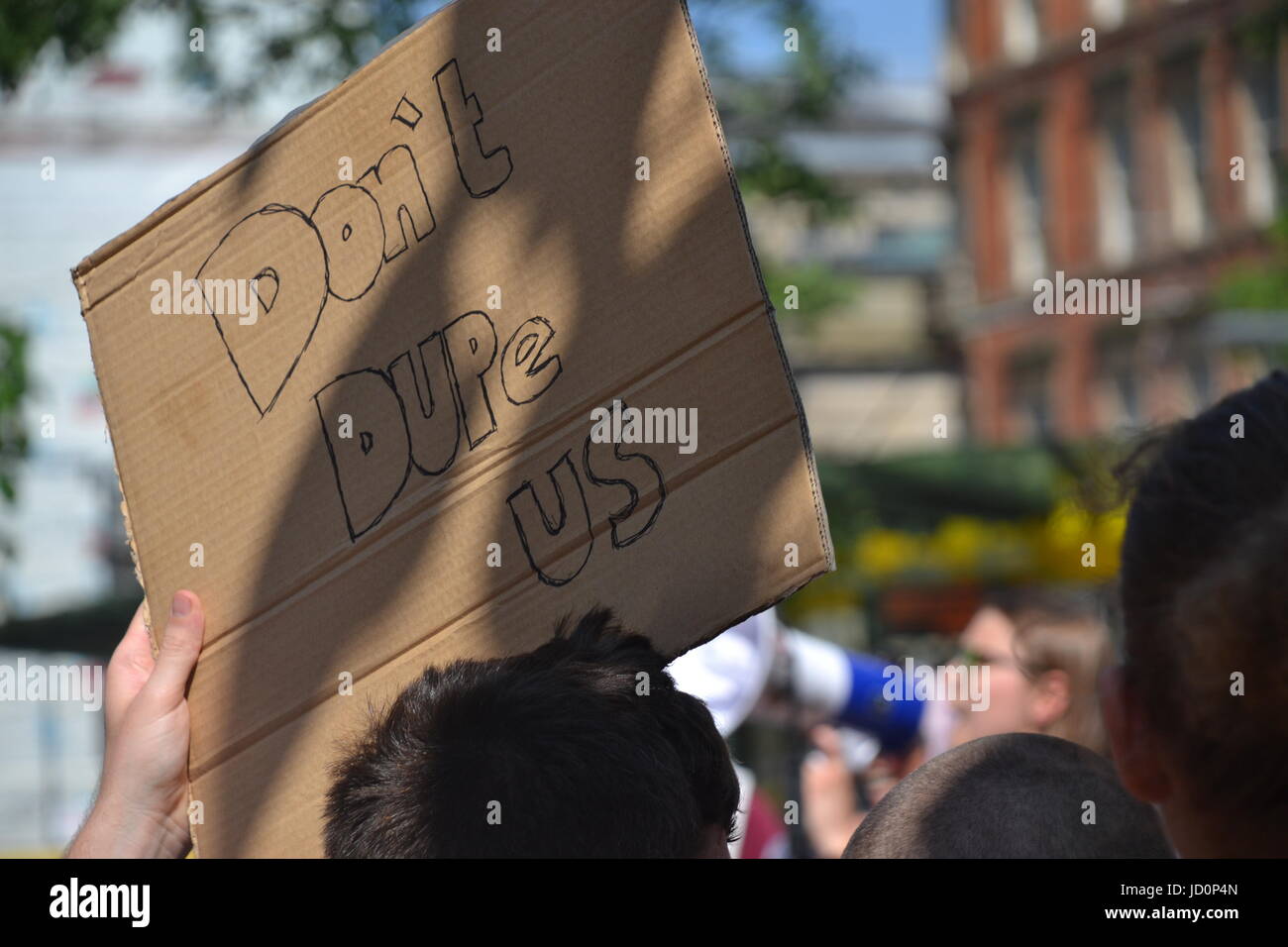 Manchester, UK. 17th June, 2017. Protestors take part in a march against the Tory-DUP government with placards and posters. ‘Justice for Grenfell: Tories Out, No DUP’ protest organised by members of the Socialist Worker’s Party, Labour Party and Jeremy Corbyn supporters in Manchester Albert Square on Saturday 17th June 2017. Credit: Pablo O'Hana/Alamy Live News Stock Photo