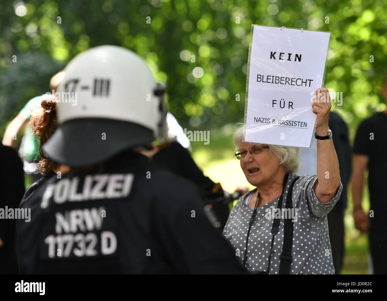 Berlin, Germany. 17th June, 2017. A woman protests against a march by the 'Identitaere Bewegung' (lit. identitarian movement) in Berlin, Germany, 17 June 2017. Various groups protested against a demonstration by the right-wing group. Photo: Paul Zinken/dpa/Alamy Live News Stock Photo