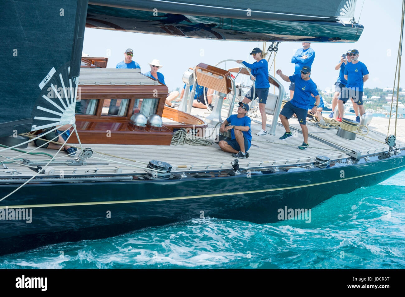 The Great Sound, Bermuda, 17th June America's Cup J Class parade. Kristy Hinze, Australian model and wife of US entrepreneur James Clarke owner of Hanuman (JK6) at the wheel. Credit: Chris Cameron/Alamy Live News Stock Photo